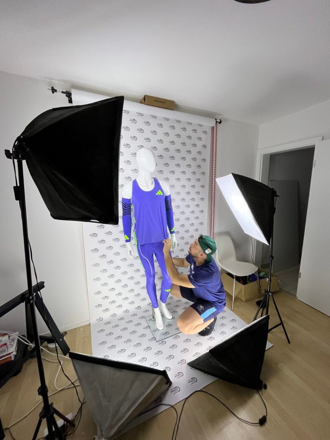 The founder adjusting a race-issued kit on a mannequin in the studio