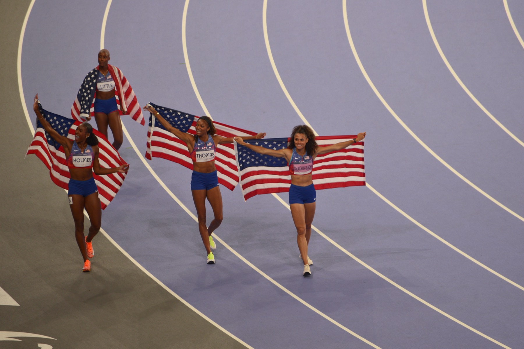 The United States women's 4x400 metres relay team celebrating gold at the Paris 2024 Olympic Games in Nike USATF kit