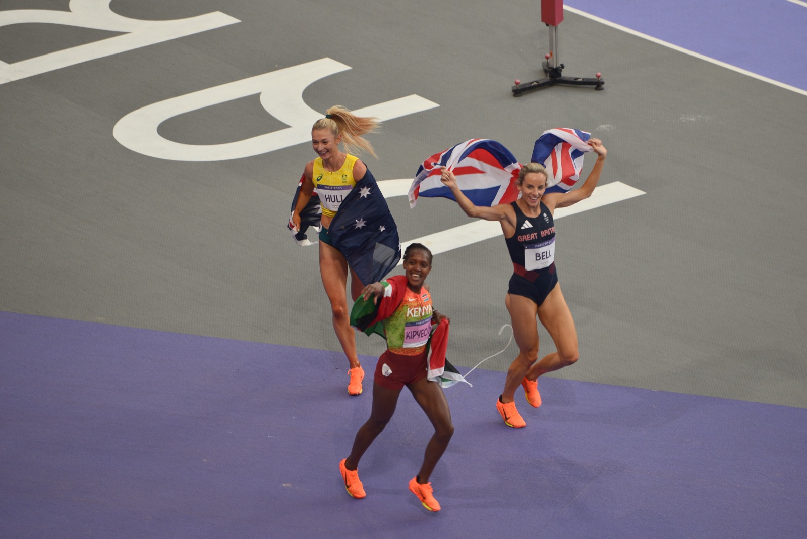 Distance runner racing in a national-team singlet, Paris 2024