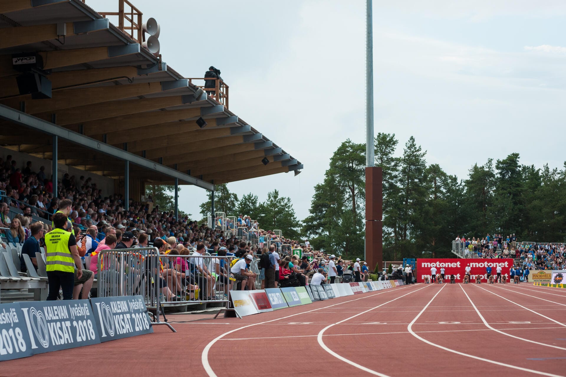 Women sprinters in crop-top kits during a 100 m final