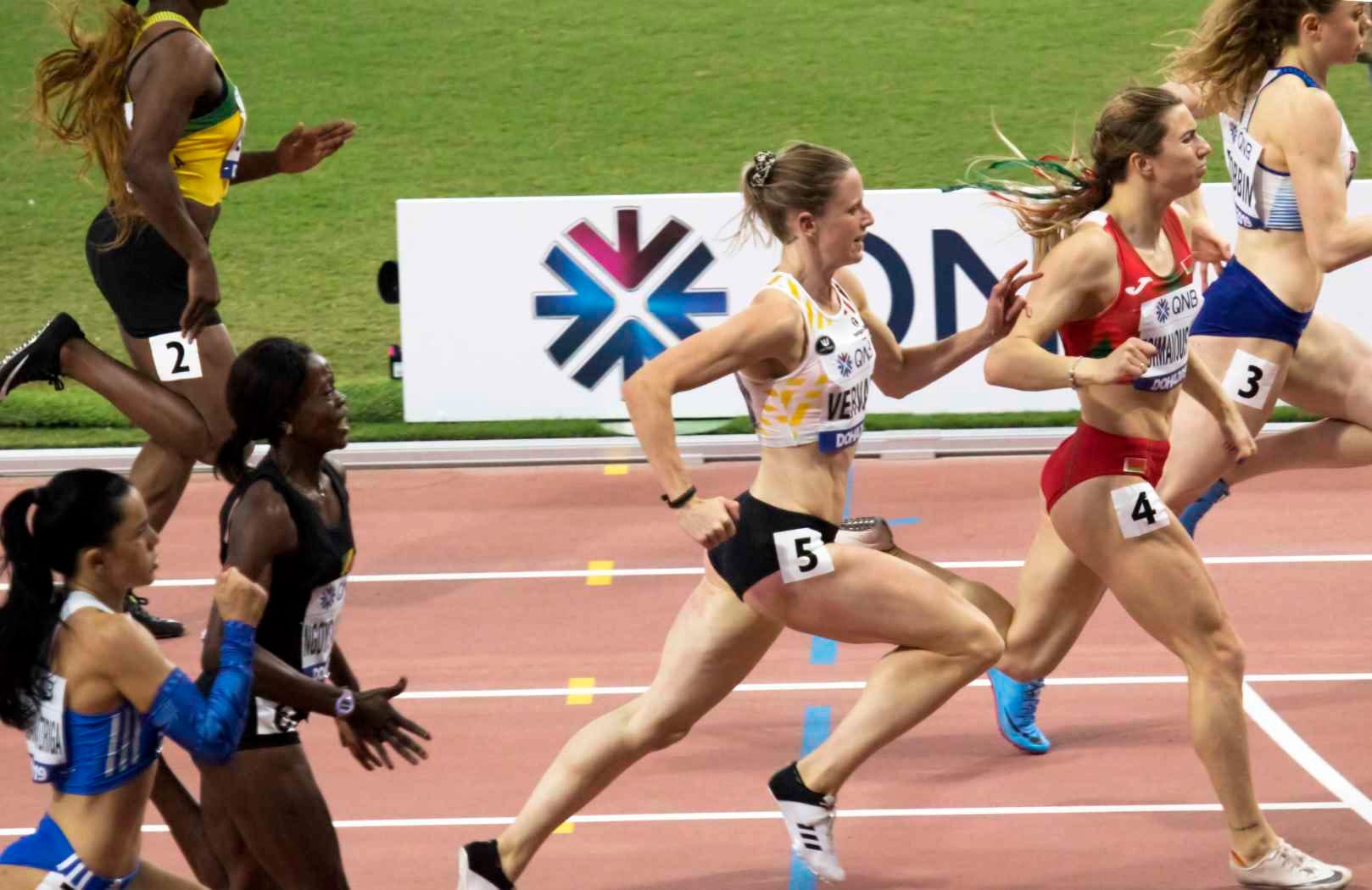 Competitors in the 200 m heats at the 2019 World Championships in Doha, in federation racing kit