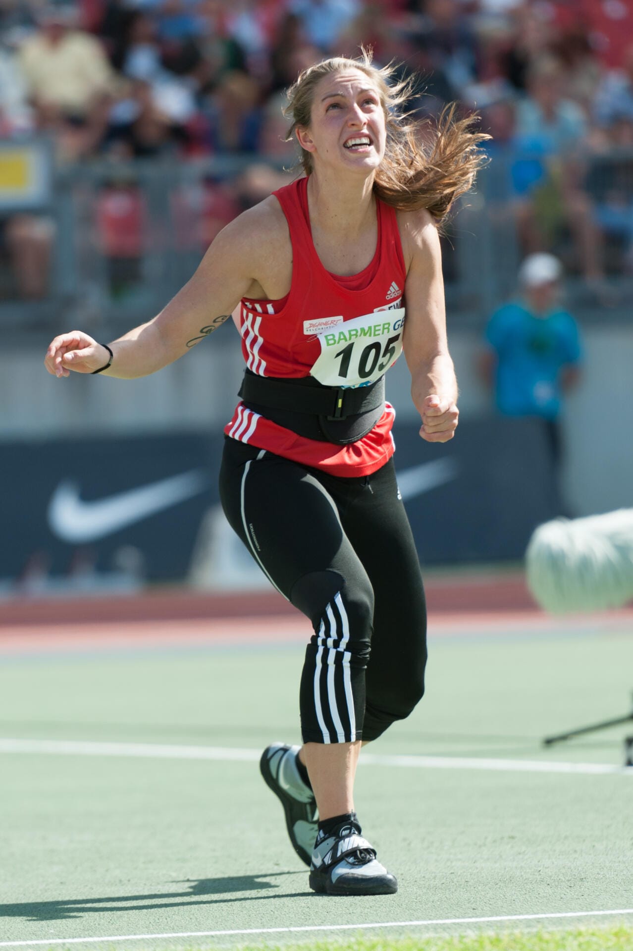 Javelin thrower at release, spiked javelin boots planted on the runway