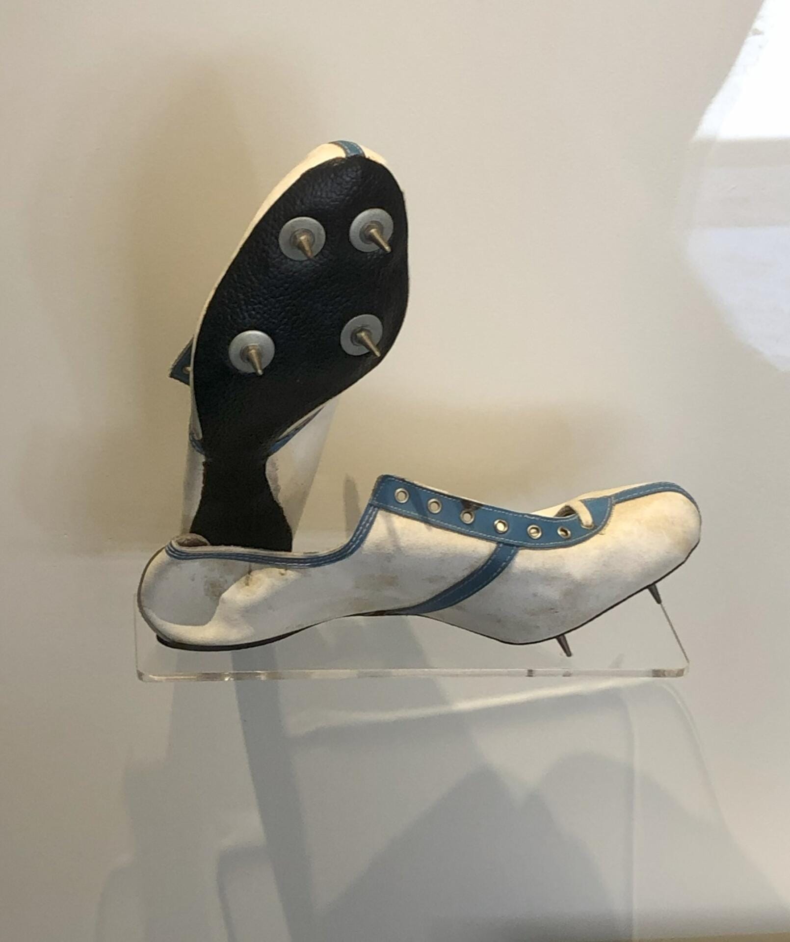 The preserved racing shoes of French distance legend Alain Mimoun in a museum display