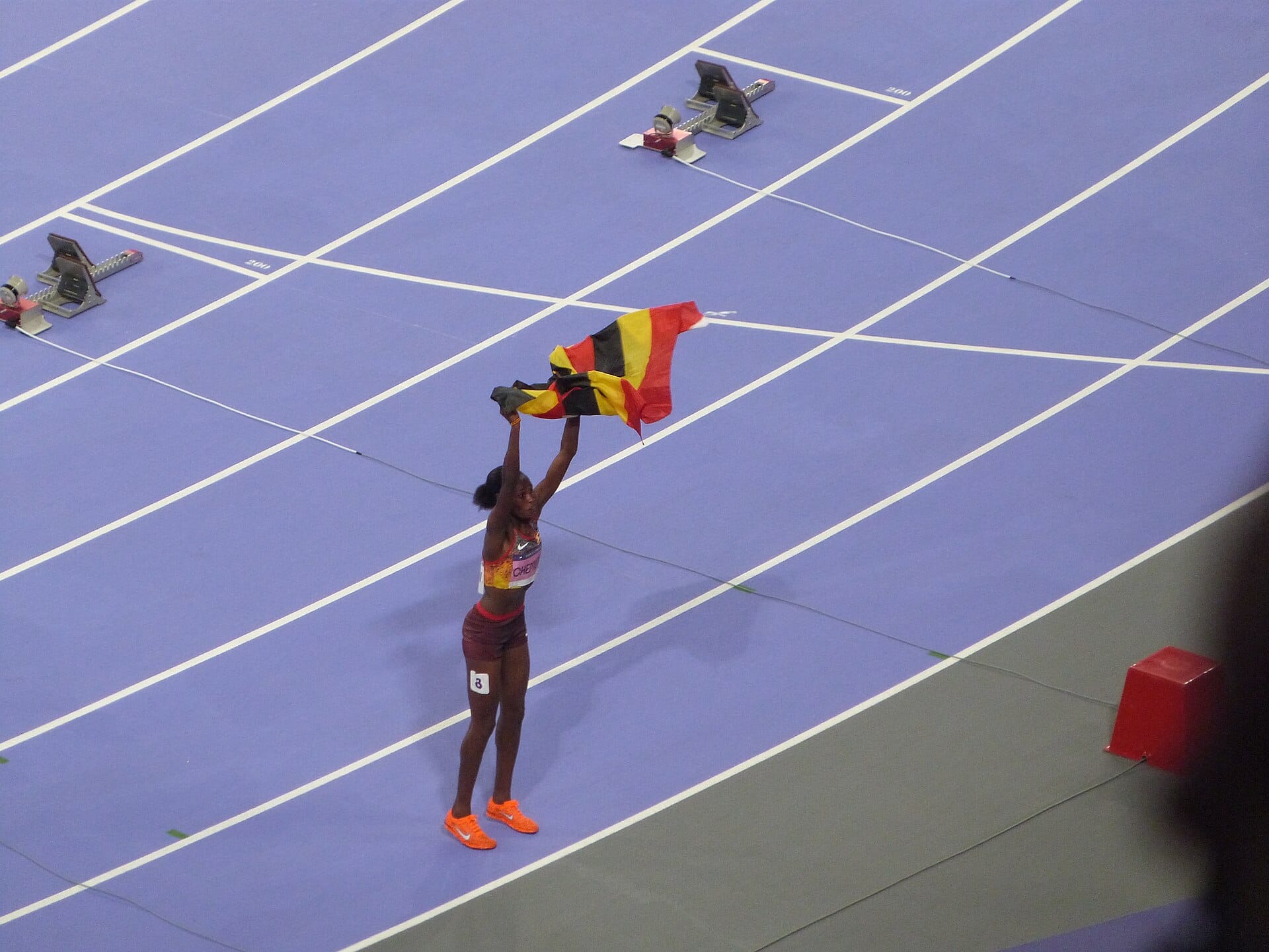 Peruth Chemutai celebrating with the Ugandan flag after the Paris 2024 steeplechase final