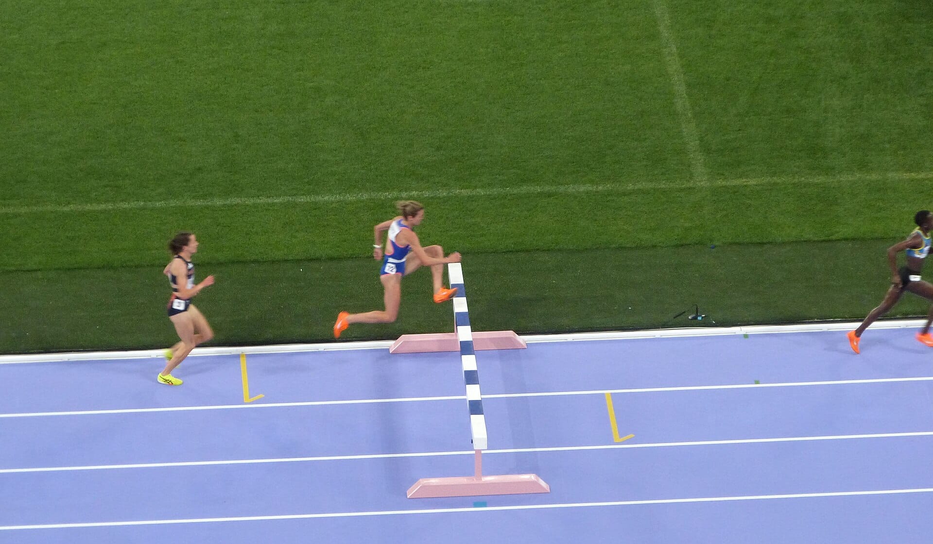 The women 3000 metres steeplechase final at the Paris 2024 Olympics, athletes clearing a barrier