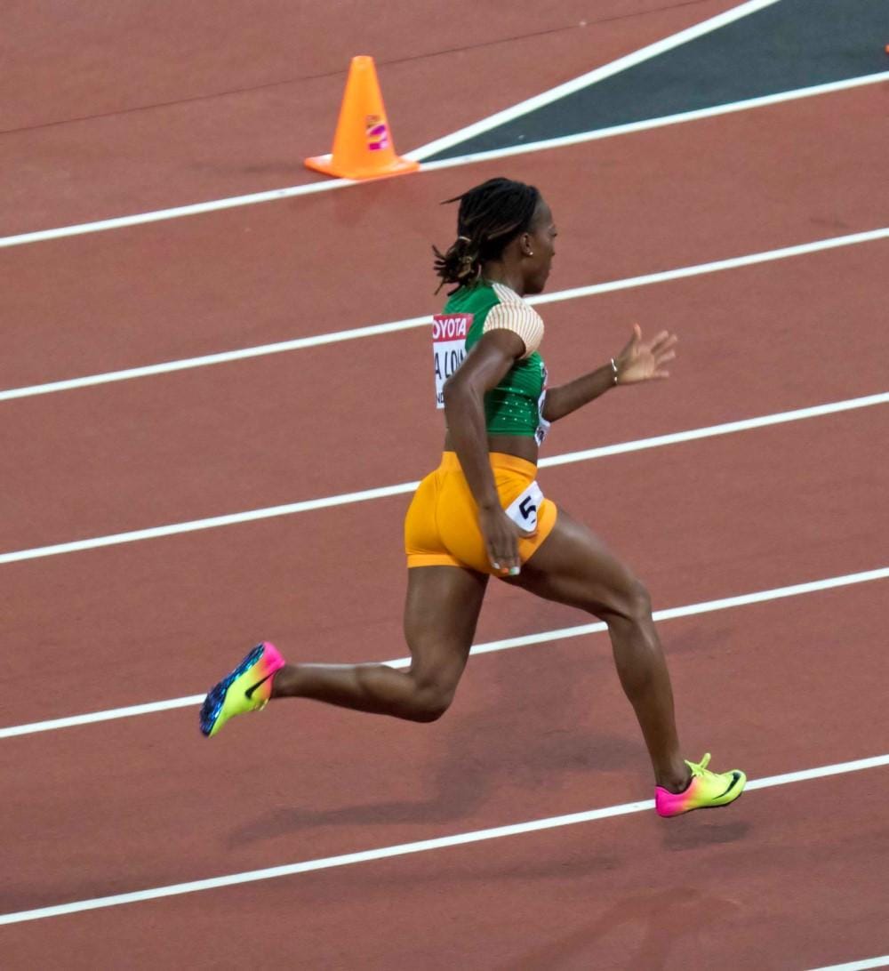 Marie-Jos&eacute;e Ta Lou sprinting in the C&ocirc;te d'Ivoire kit at the London 2017 World Championships