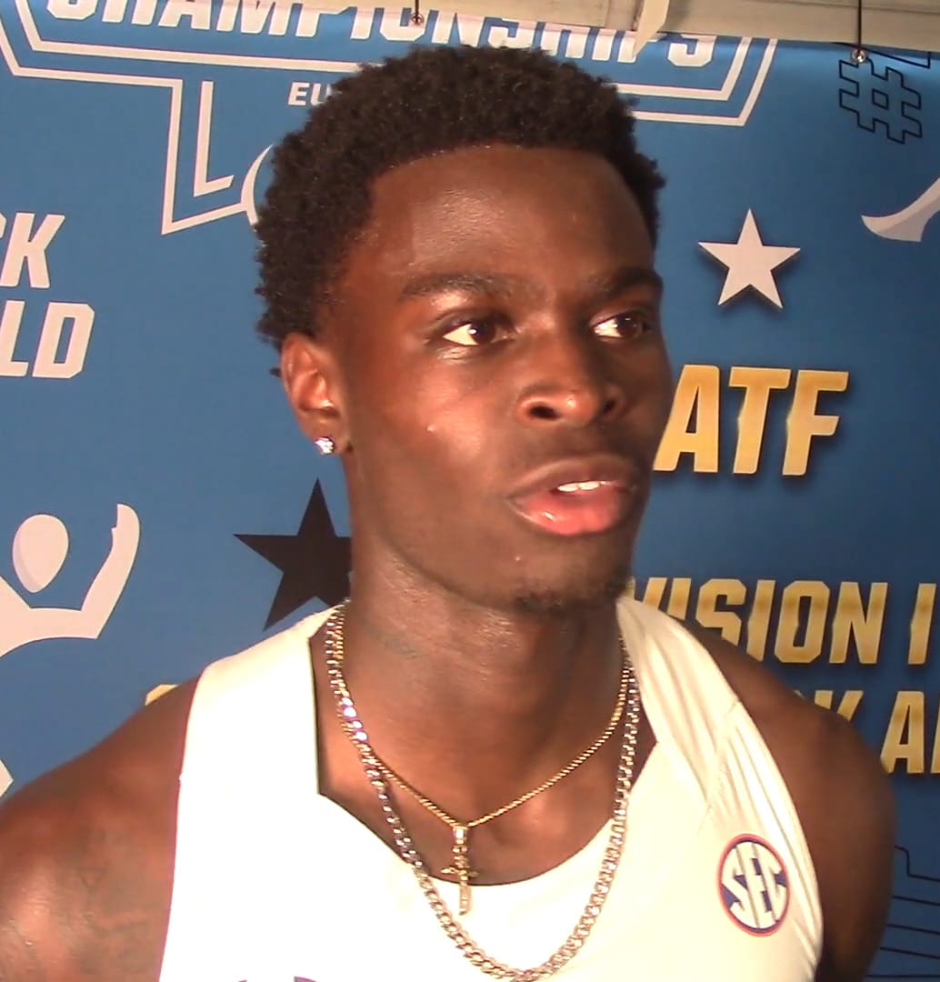 Ja'Kobe Tharp interviewed in his Auburn kit in front of the NCAA championships backdrop